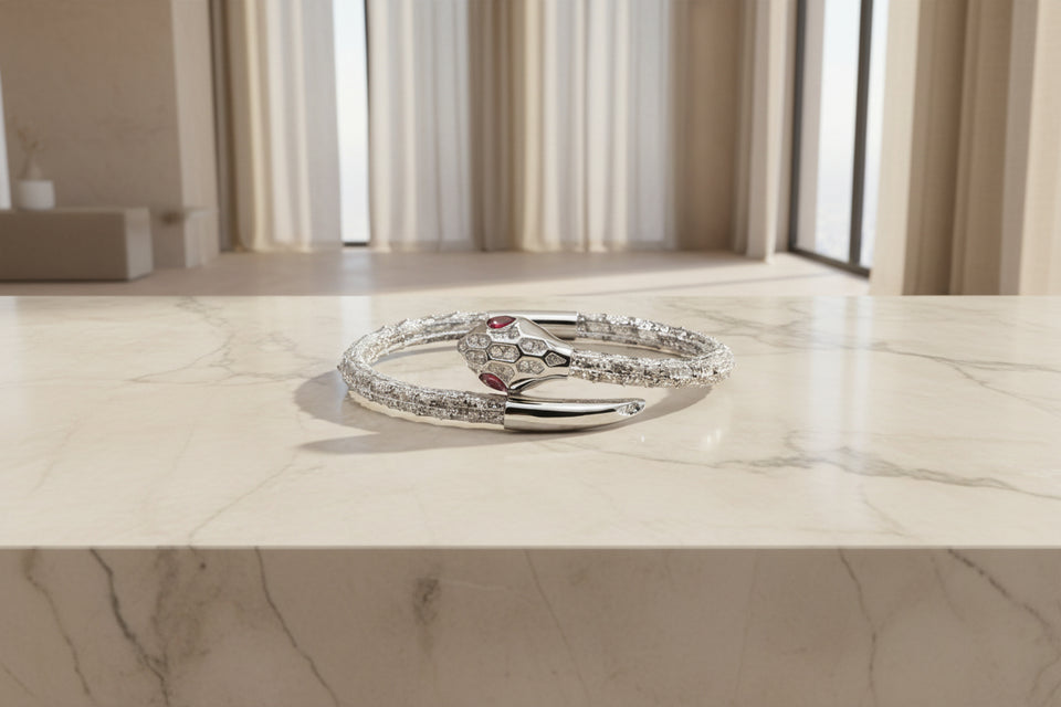 A silver-colored leather bracelet with a snake shape design and a silver head, featuring zirconia setting.