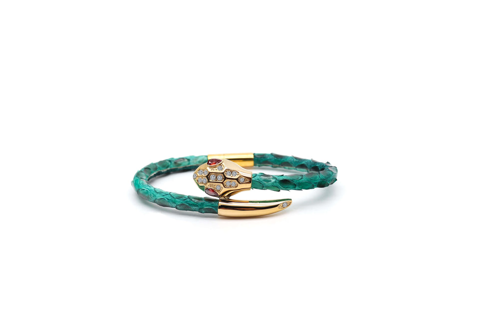 A green python leather bracelet with a gold-plated snake head crystal and cubic zirconia embellishments