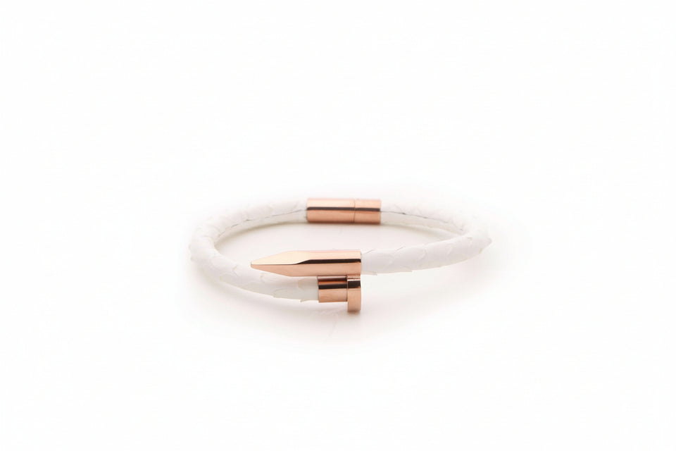 White bracelet with rose gold accents on a white background