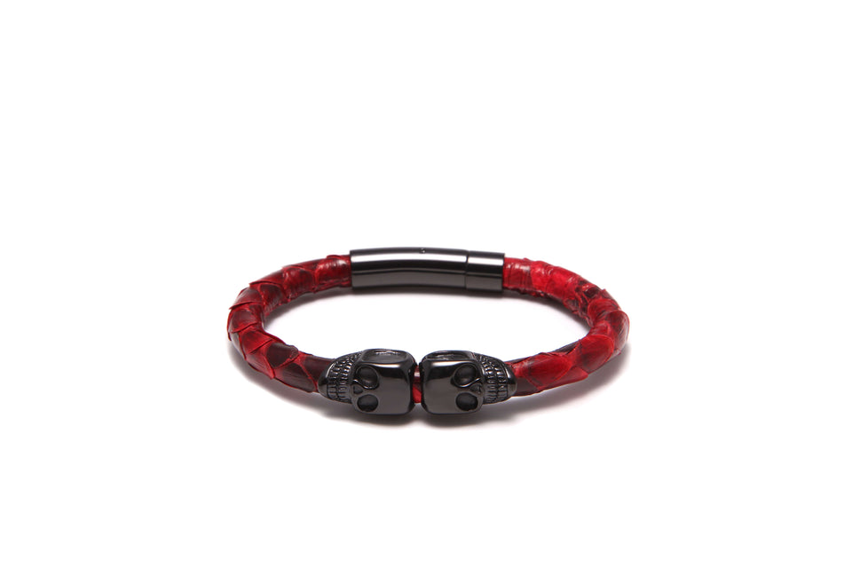 A red and black python leather bracelet with a skull shape design and black clasps.