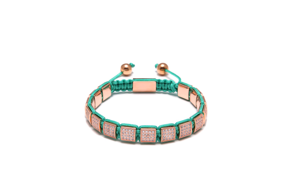 A bronze and turquoise cubic zirconia diamond bracelet with 18k rose gold plating.