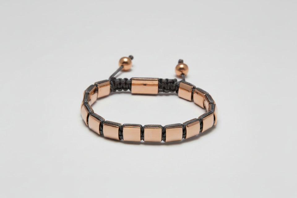 Bracelet with rose gold and black accents on a light gray background