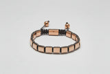 Bracelet with rose gold and black accents on a light gray background